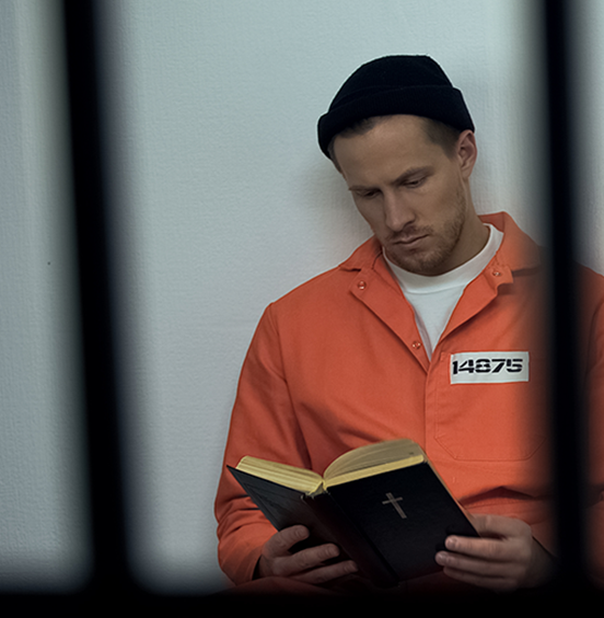 Inmate reading Bible