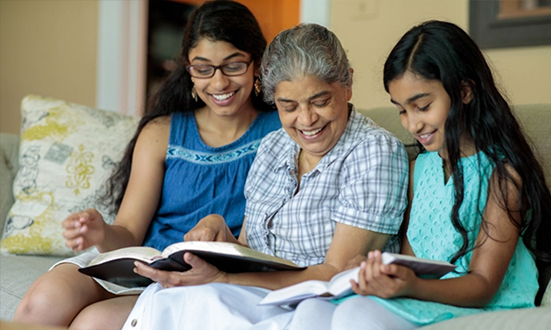 Woman and girls reading Bible - American Bible Society